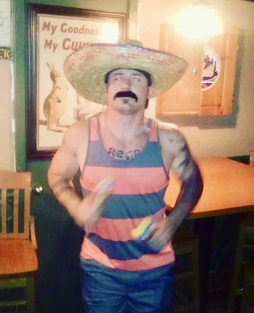 Sonny in a sombrero and fake mustache at a bar